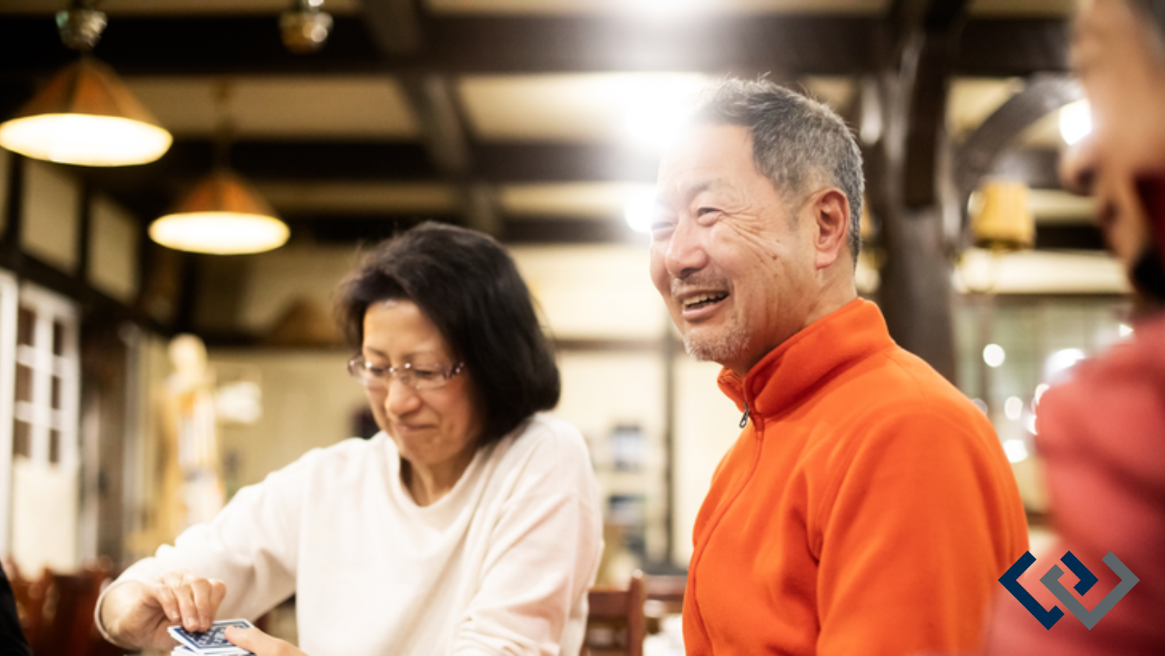 two people smiling, sitting at a table