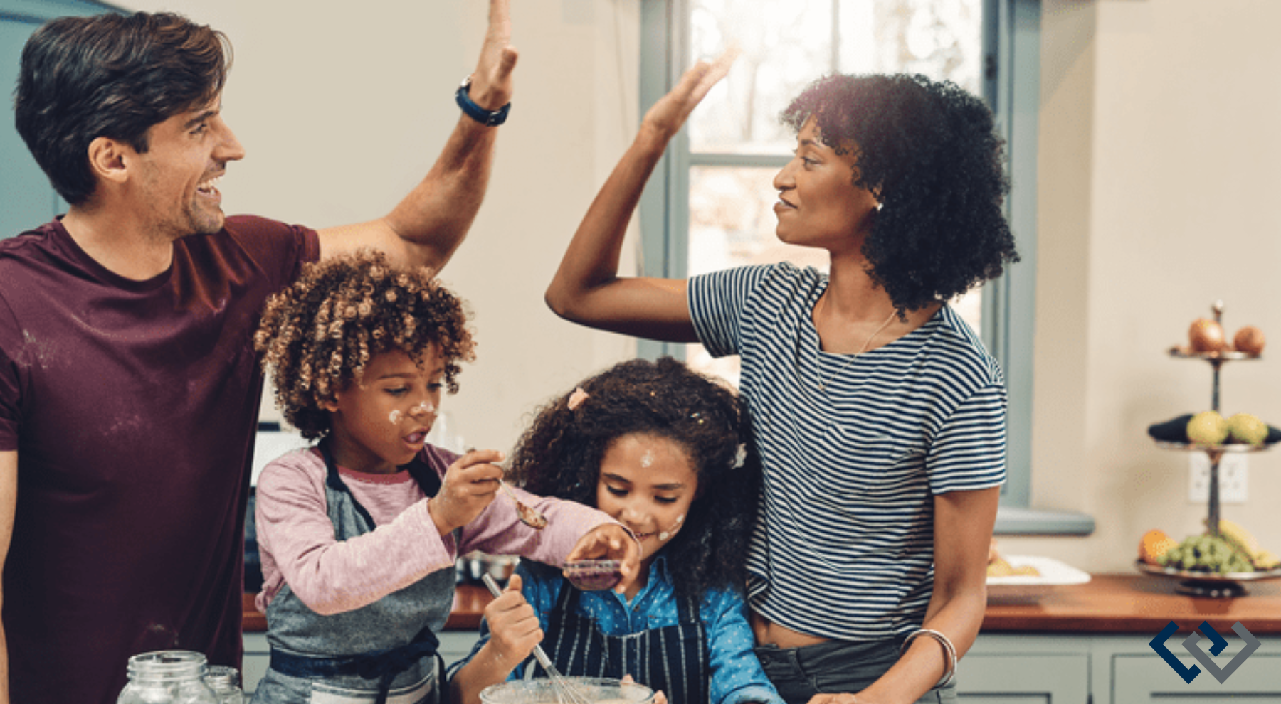 two adults and two children in a kitchen, adults are slapping a high five