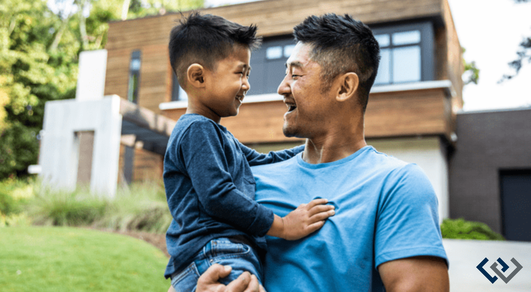 man holding a child in his arms, looking face-to-face