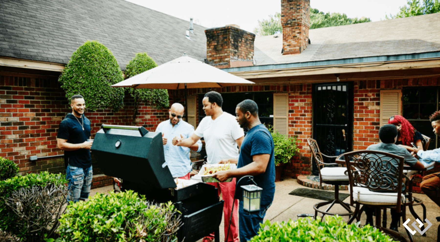 A small group of people, in a backyard. Some gathered near a grill