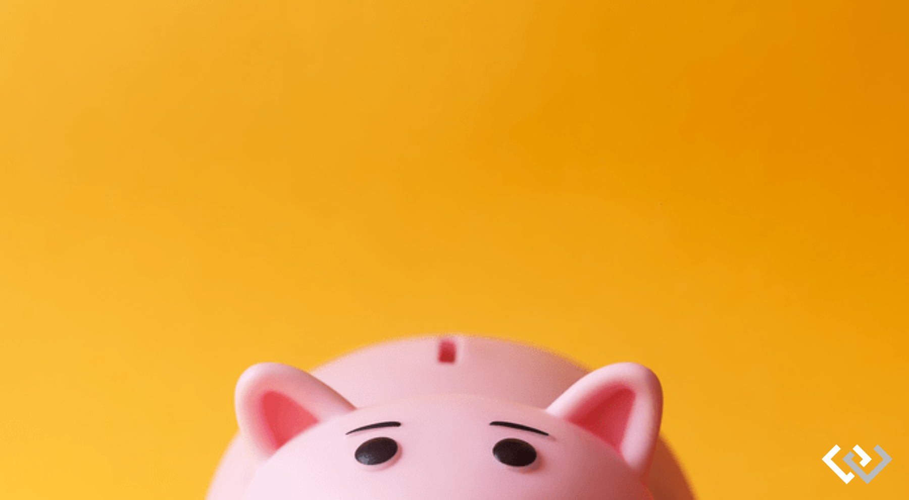 Bright orange background, lower portion of the frame is the top of a pink piggy bank, you can see the ears, eyes, and the back with a coin slot